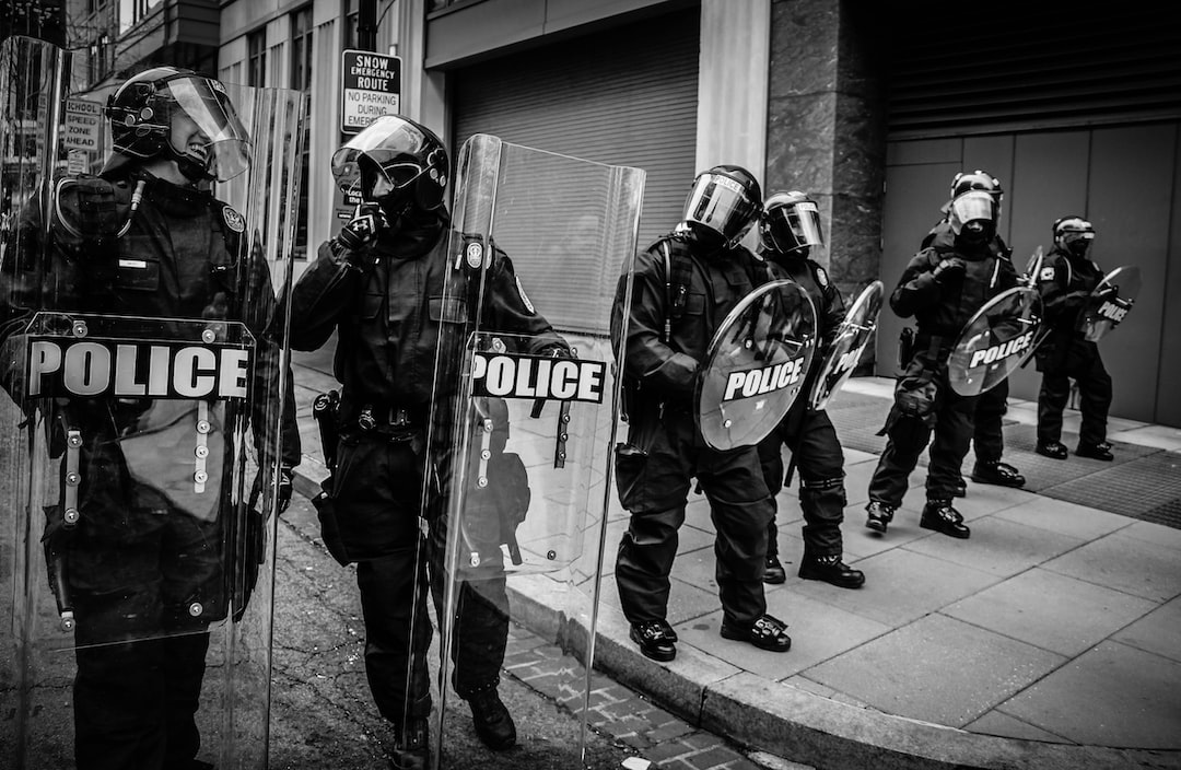 police in a line wearing riot gear